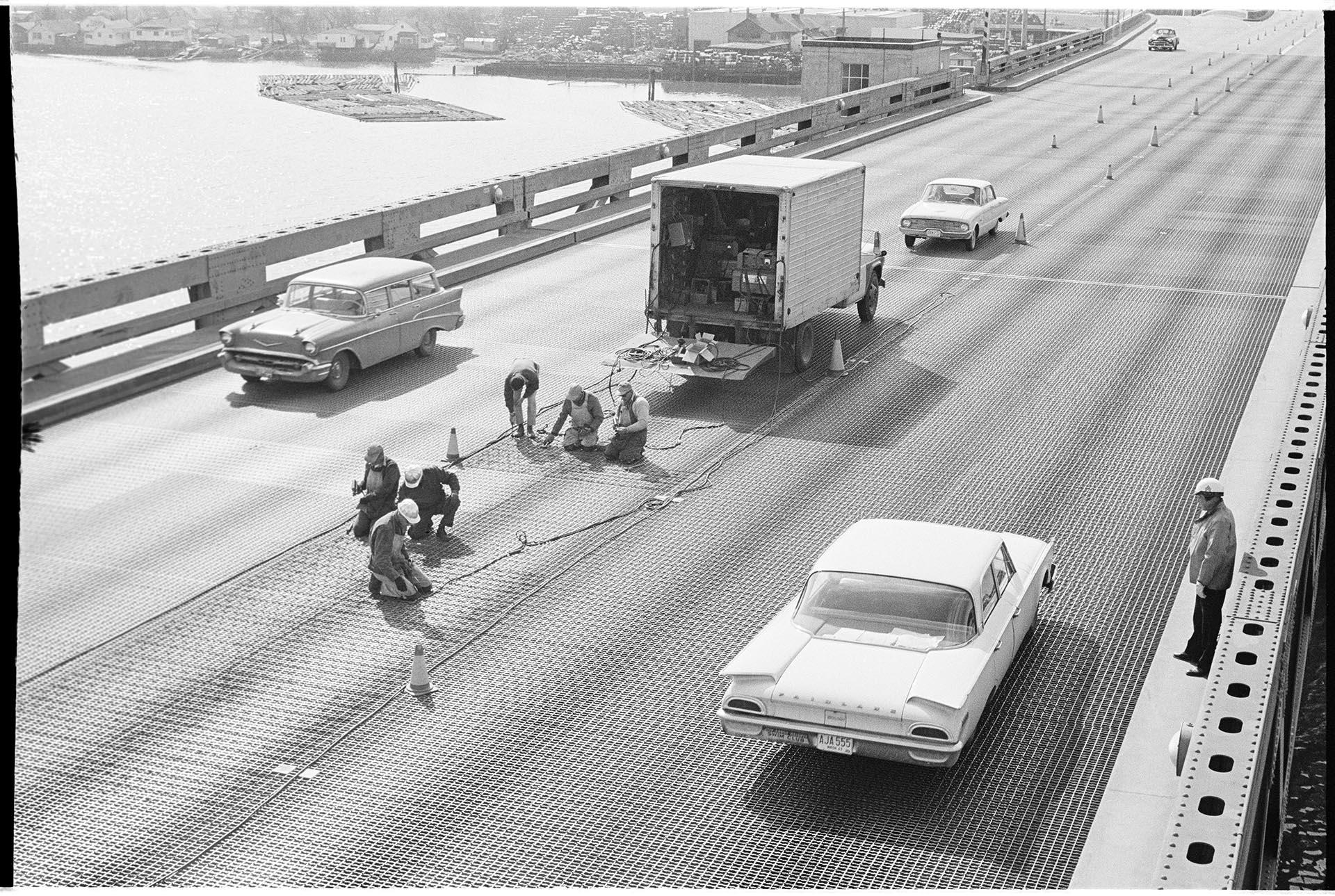 Image of Workers skidproofing 1st Avenue S. bridge, Seattle, March 23, 1964